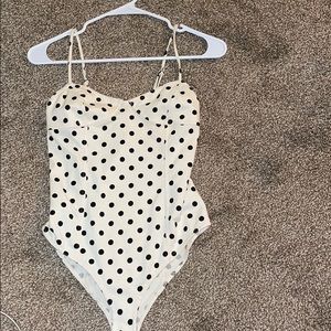 Cream bodysuit with black dots.